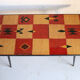 Vintage coffee table in laminate with geometric design, with tapered legs.
