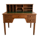 Antique wooden desk with a sloped top and green writing pad.