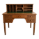 Antique wooden desk with a sloped top and green writing pad.
