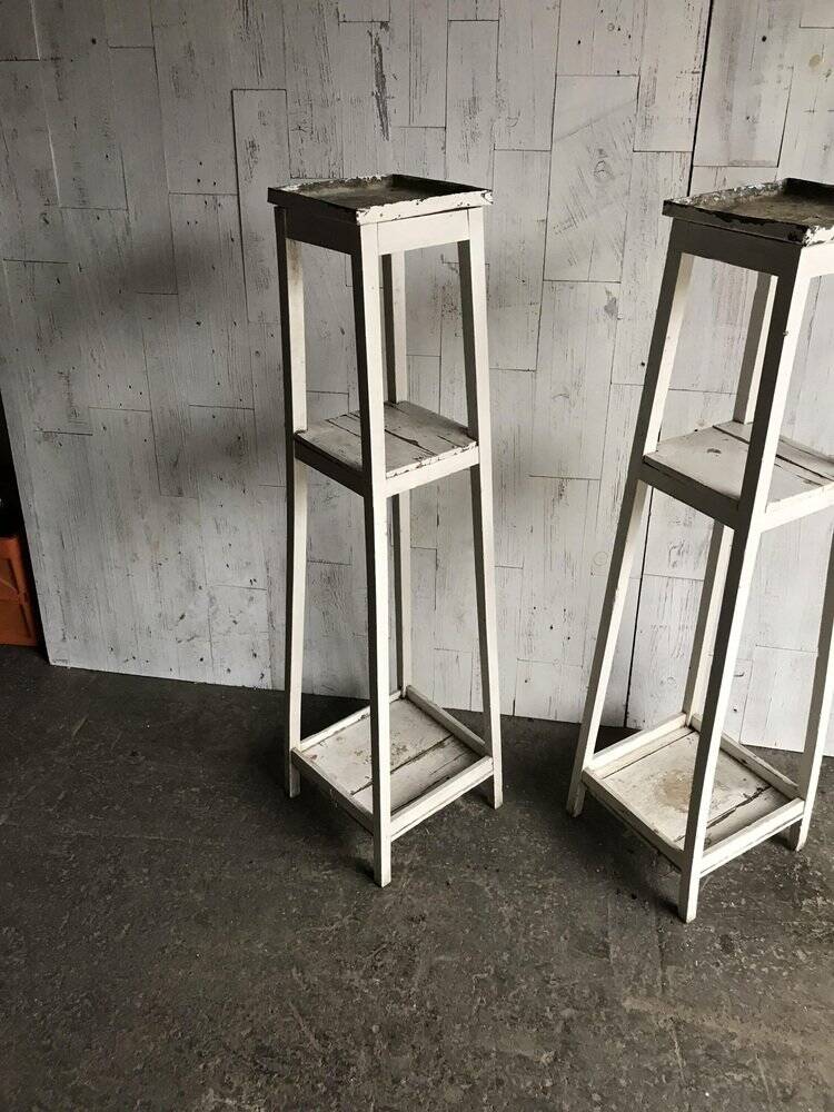 Two white vintage mid-20th century wooden plant stands, 3-tier shelves.