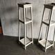 Two white vintage mid-20th century wooden plant stands, 3-tier shelves.