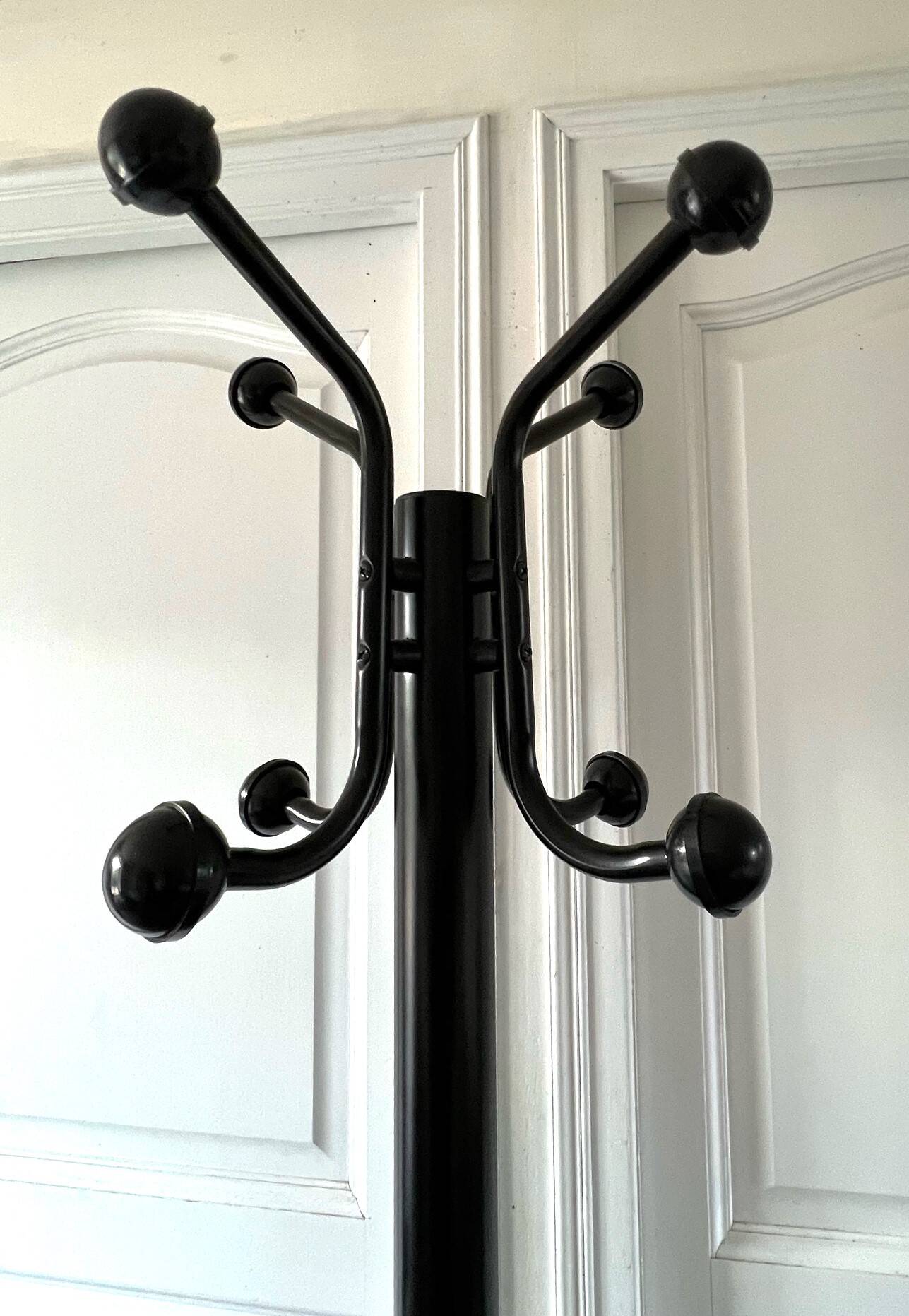 Black metal parrot coat rack on marble base