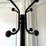 Black metal parrot coat rack on marble base