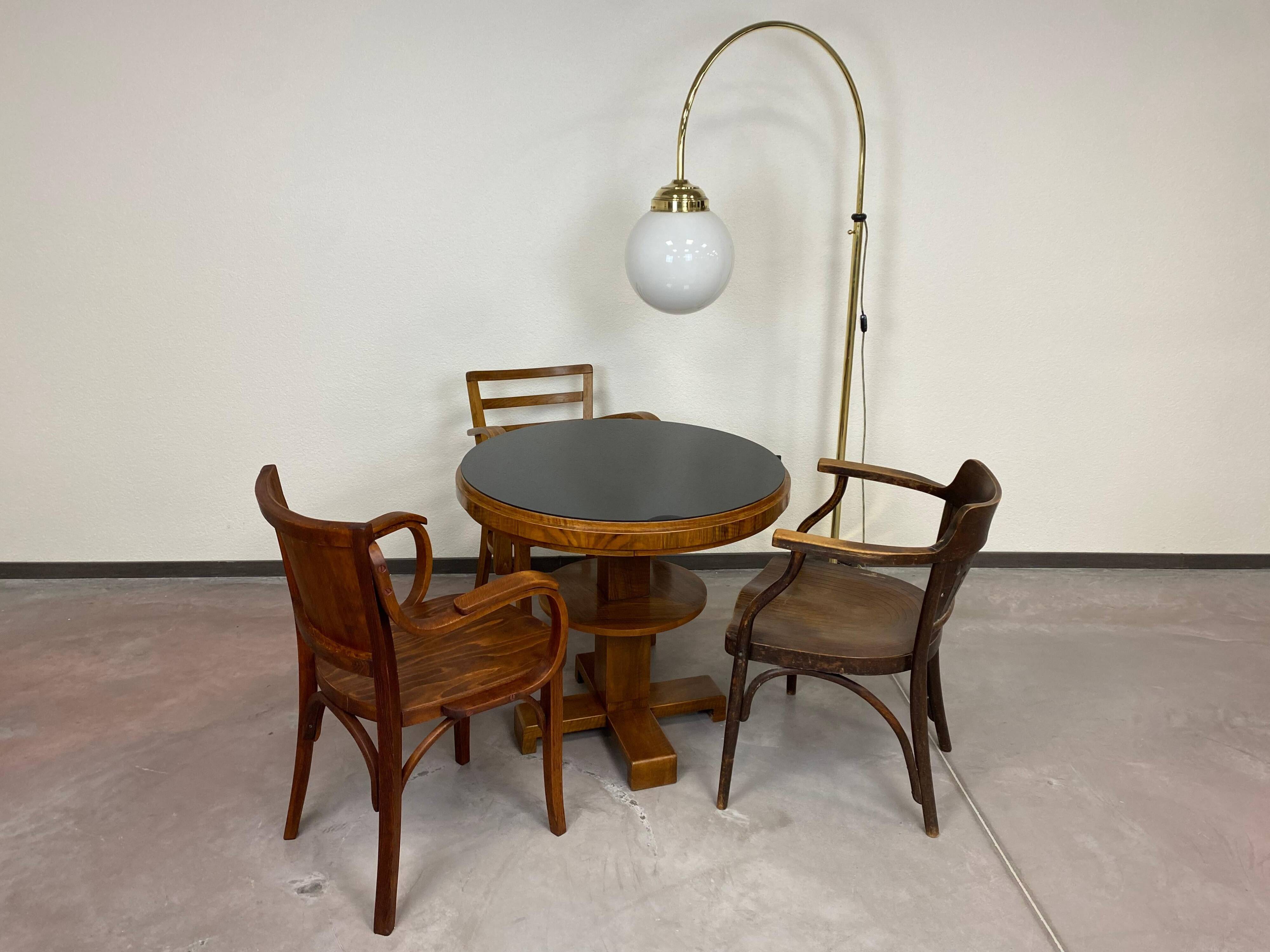 Art Deco game table with a black glass top.