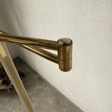 Floor lamp with articulated arm in brass-plated metal