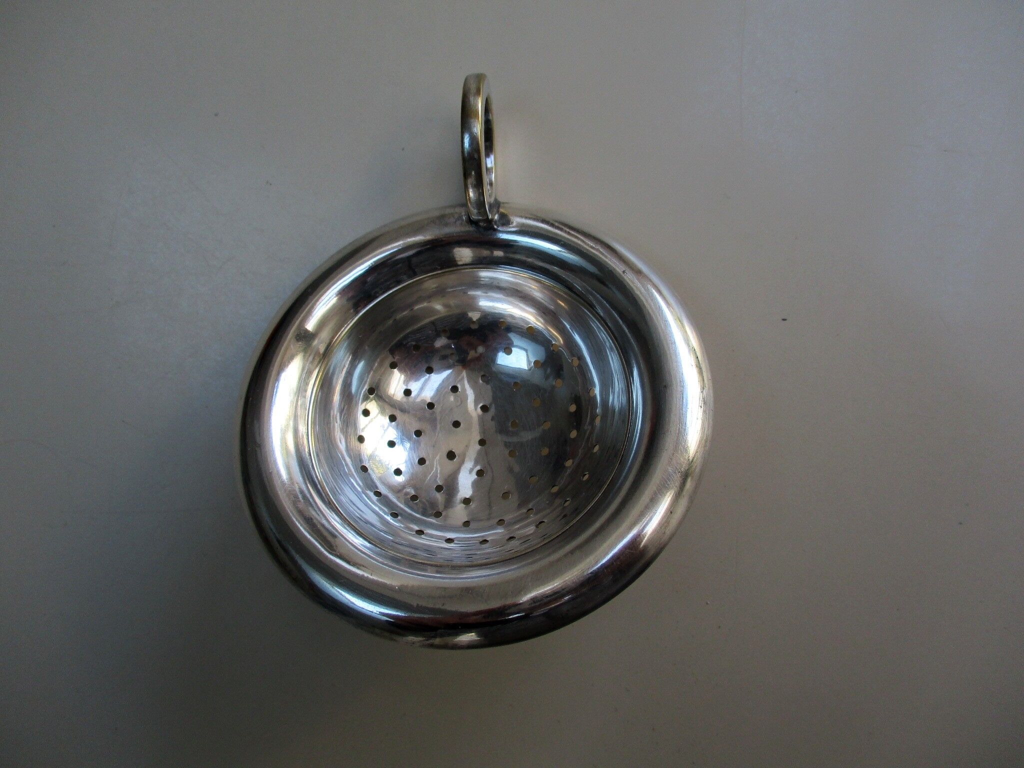 Silver metal tea strainer