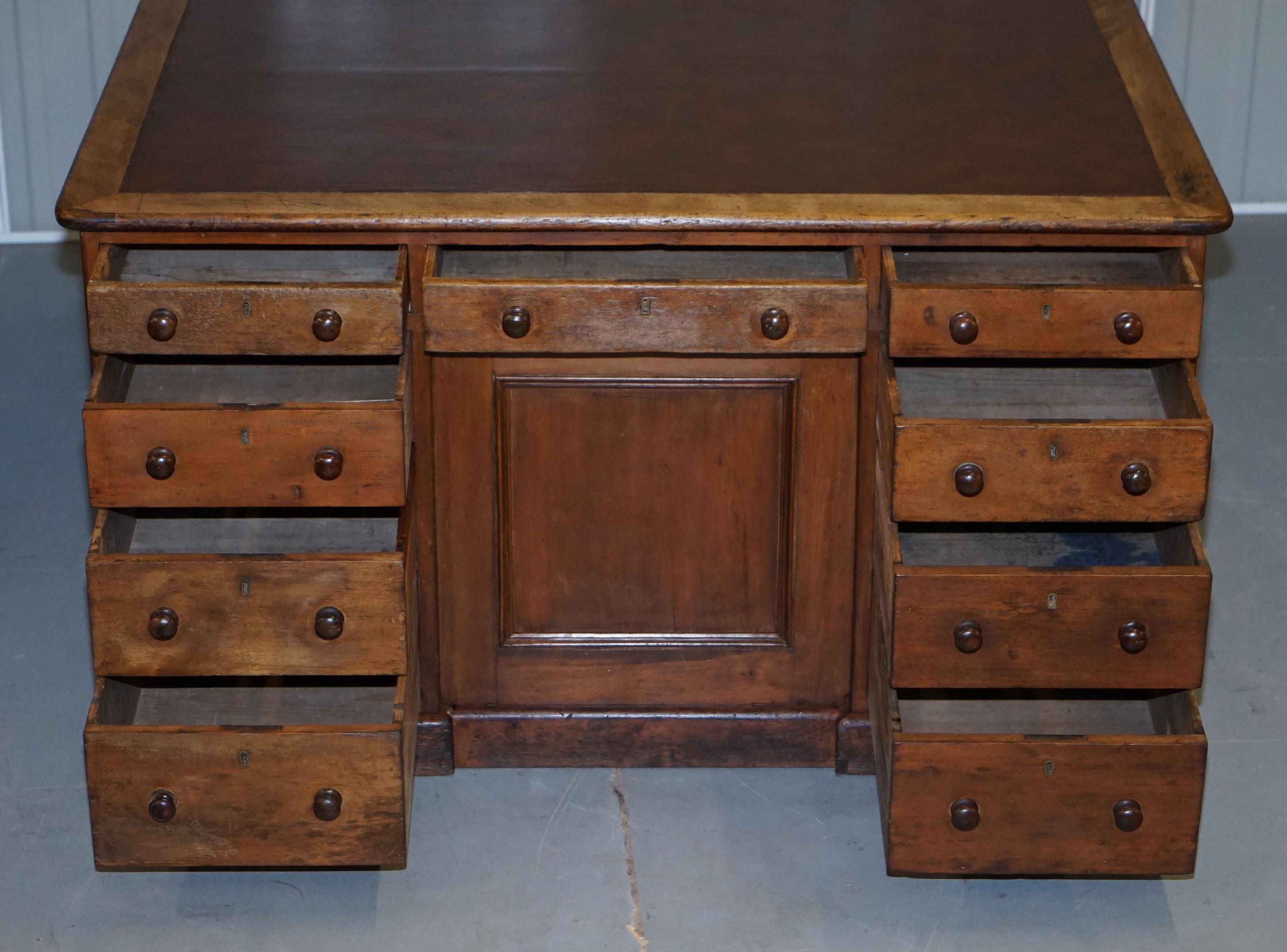 Antique Victorian oak kneehole desk with 18 double-sided drawers.