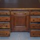 Antique Victorian oak kneehole desk with 18 double-sided drawers.
