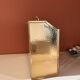 Brass and wood magazine rack in Hollywood Regency style.