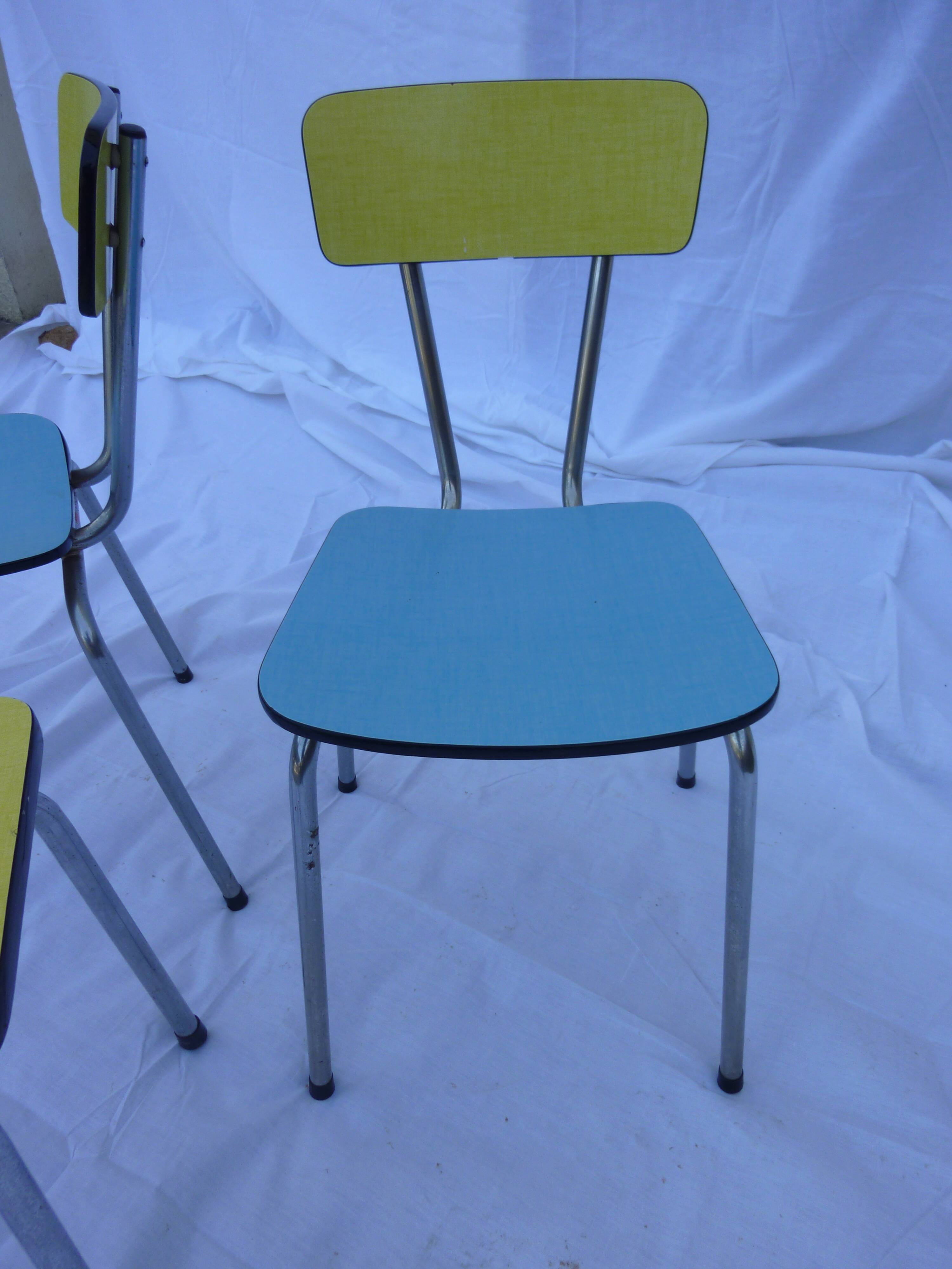 Two chairs and a yellow and blue stool in formica