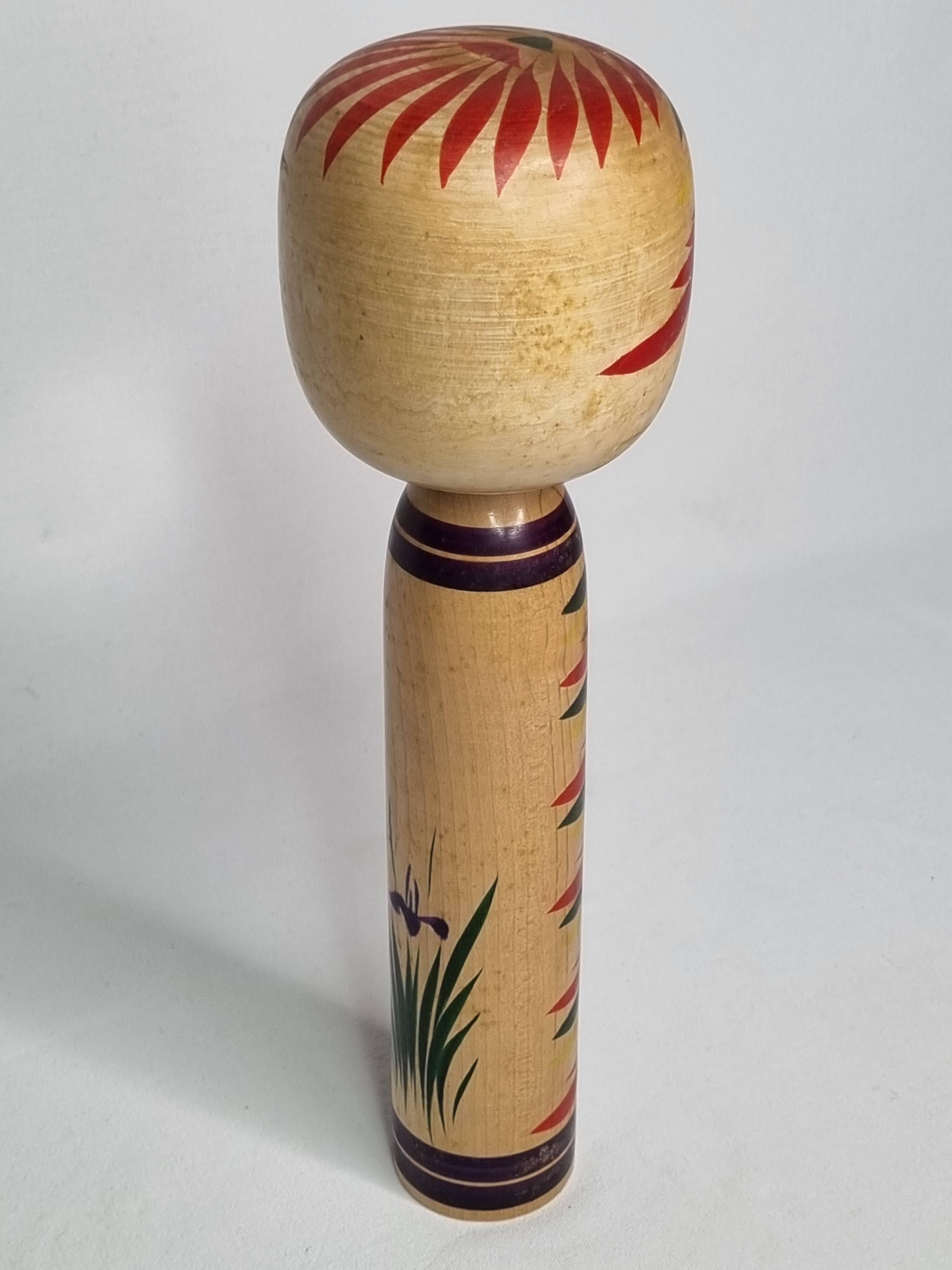 Japanese Kokeshi doll dated 1986, signed and numbered, hand-painted multi-colored floral decoration,