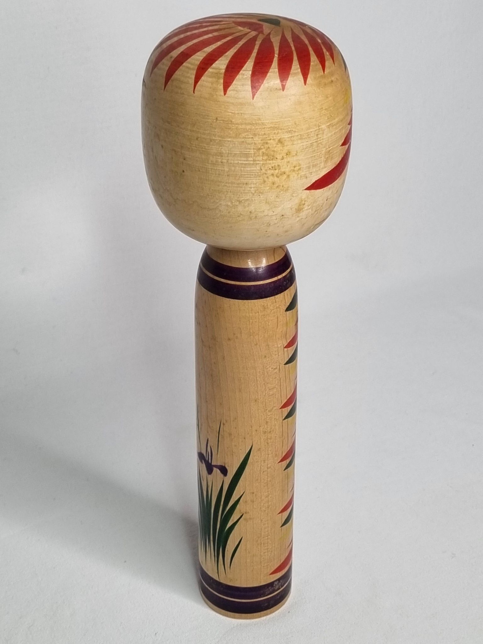 Japanese Kokeshi doll dated 1986, signed and numbered, hand-painted multi-colored floral decoration,