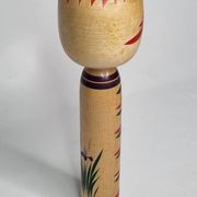 Japanese Kokeshi doll dated 1986, signed and numbered, hand-painted multi-colored floral decoration,