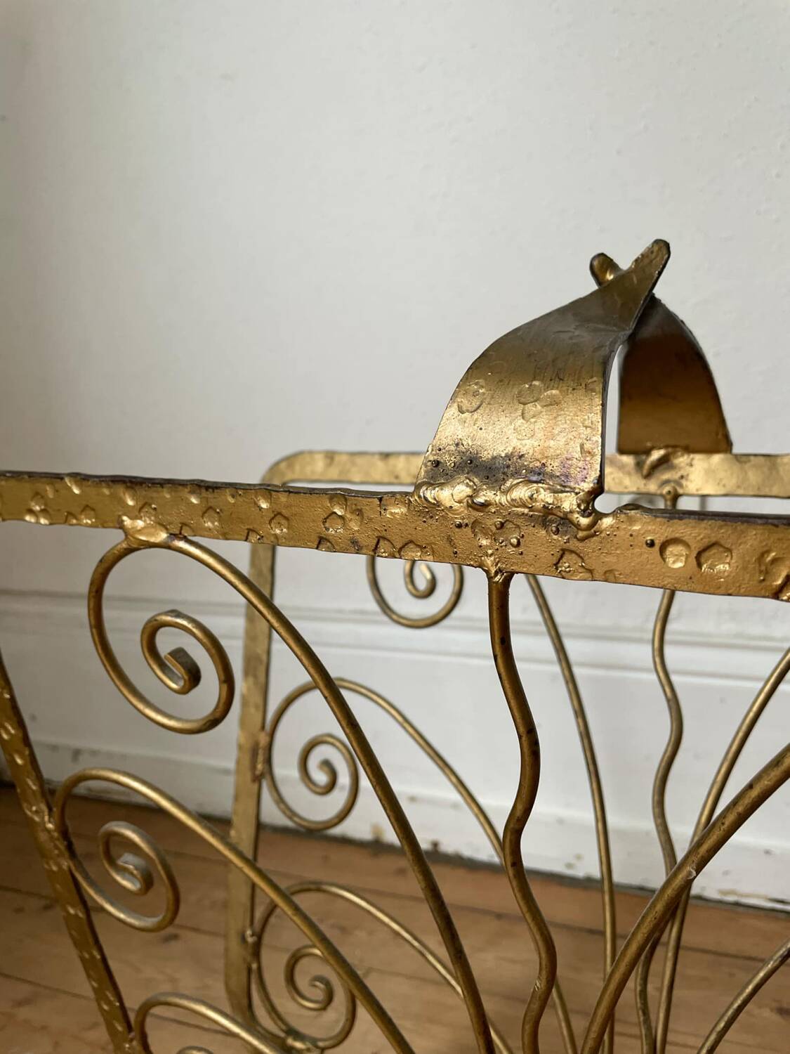 Vintage wrought iron magazine rack with gold butterfly design
