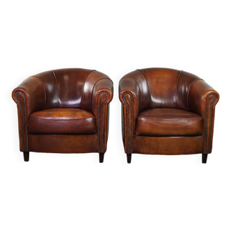 Set of two club armchairs made of sheep leather in a beautiful warm dark color