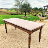 Old French farmhouse table in walnut with turned legs.