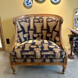 Armchair in a wooden confessional style with black and beige cotton.