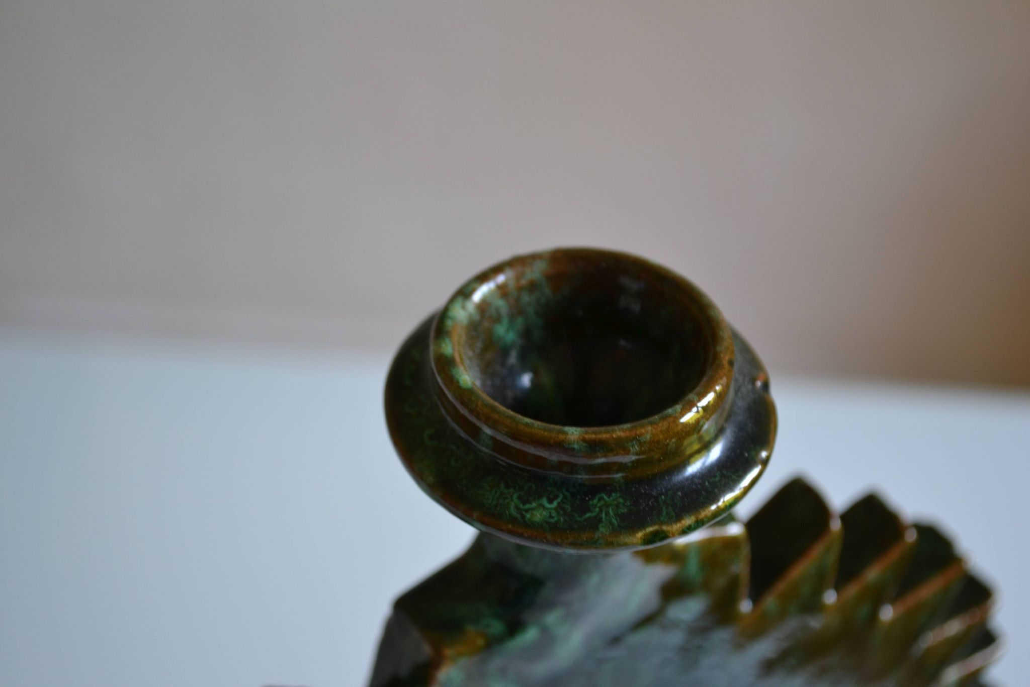 Green ceramic sun candlestick from Tamegroute, Morocco.