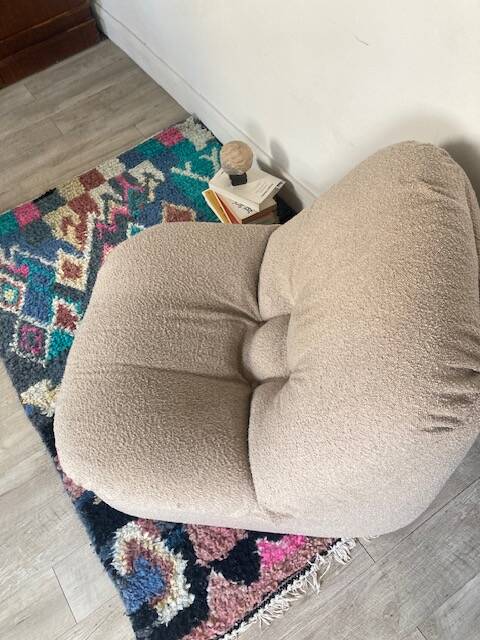 Vintage armchair reupholstered in boucle fabric.