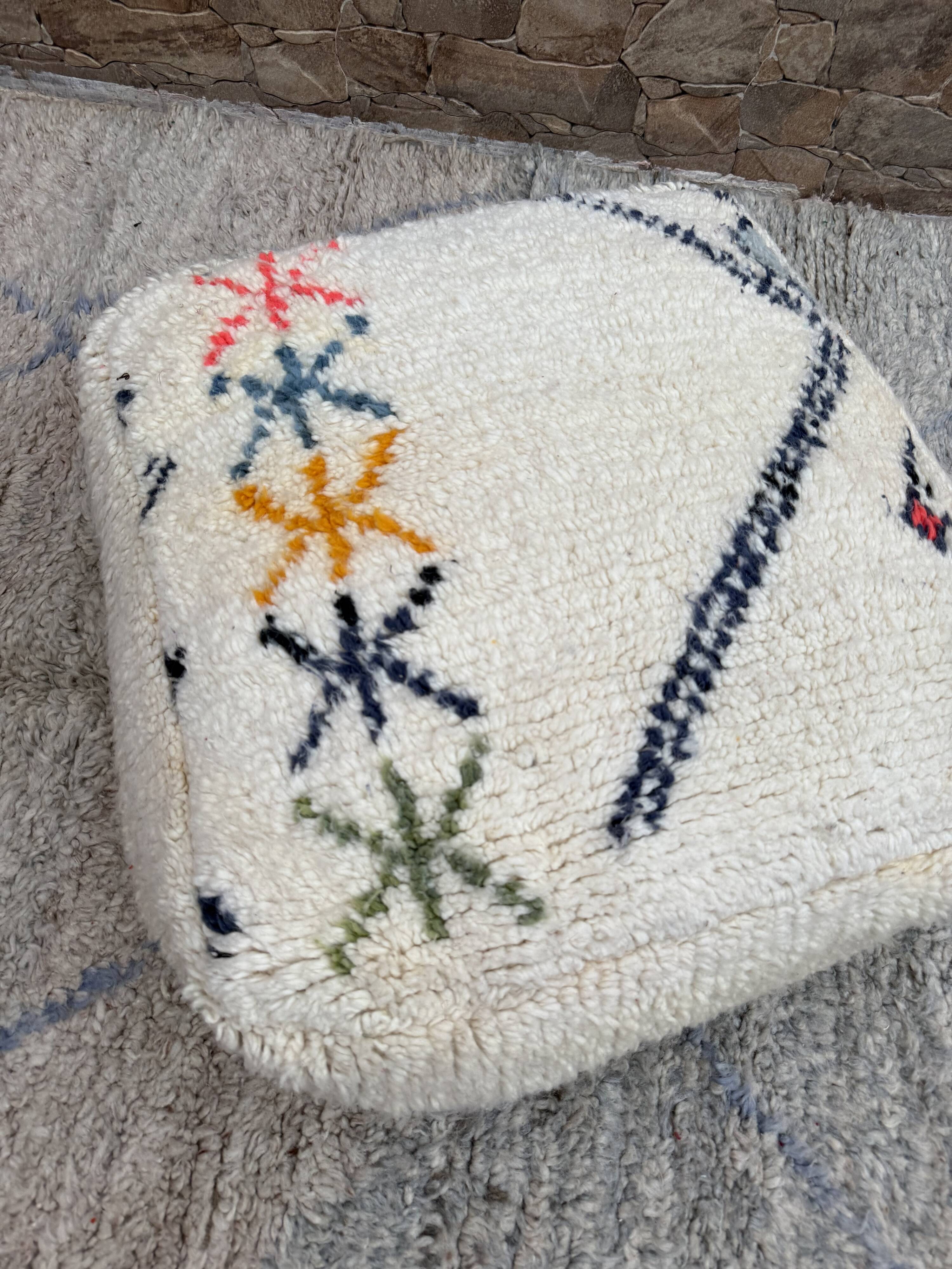 Berber floor pouf: Handwoven Moroccan wool cushion.