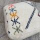 Berber floor pouf: Handwoven Moroccan wool cushion.
