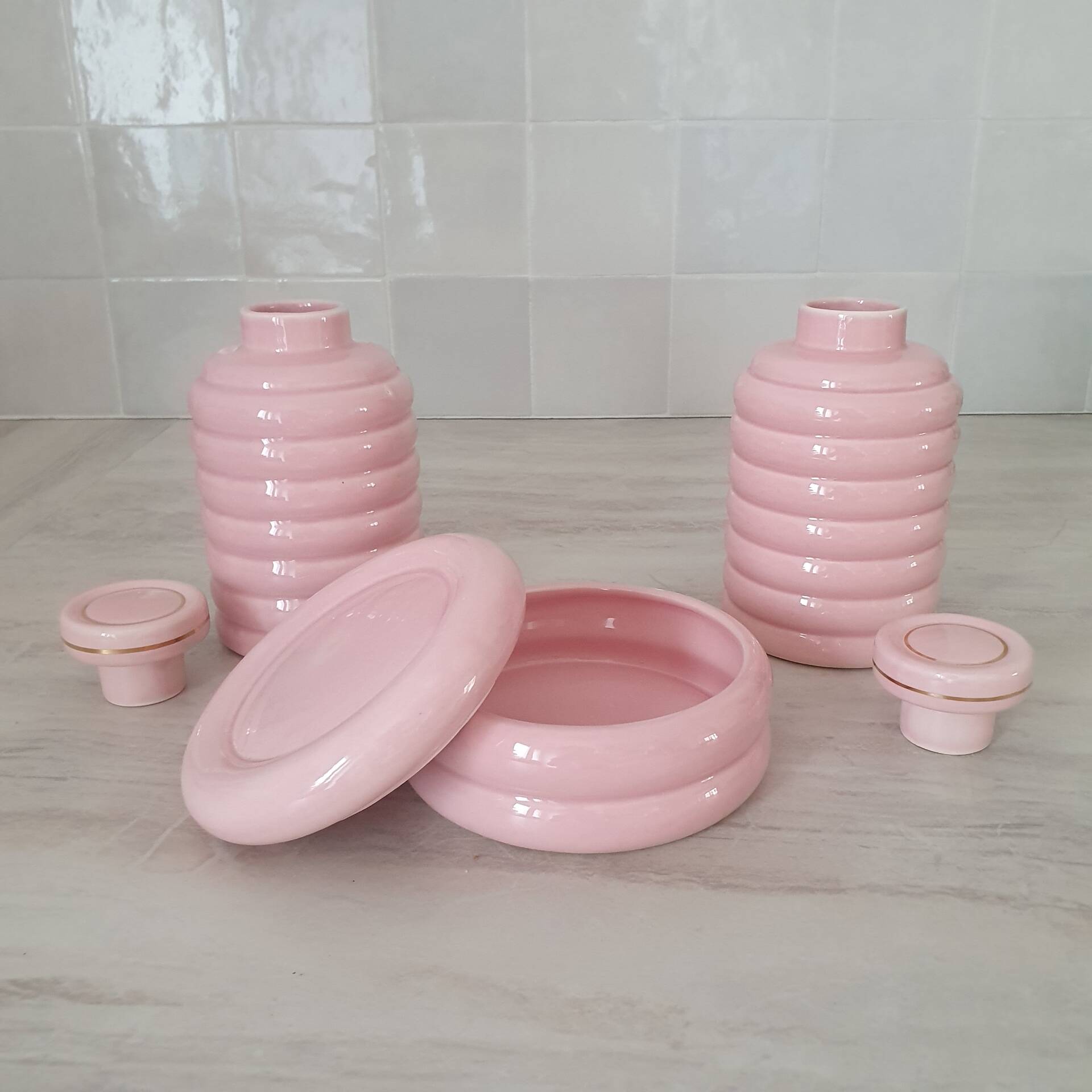 Set of pink and gold ceramic bathroom accessories