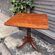 19th-century solid mahogany table with a tilting top and brass mechanism.