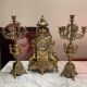 Fireplace trim clock and adornment of antique bronze candelabra