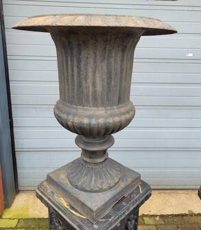 Large antique cast iron vases on pedestal