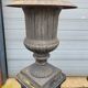 Large antique cast iron vases on pedestal