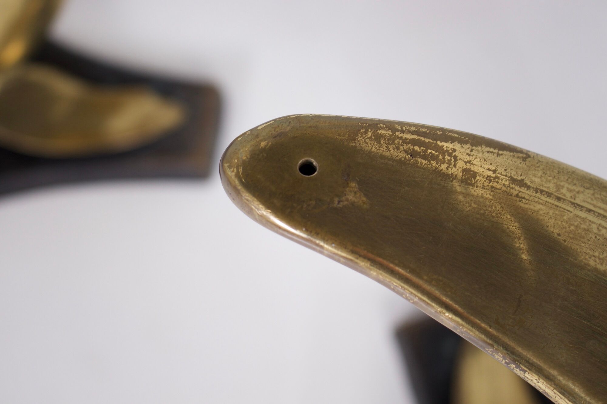 Solid brass dolphin console feet.