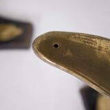 Solid brass dolphin console feet.