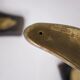 Solid brass dolphin console feet.