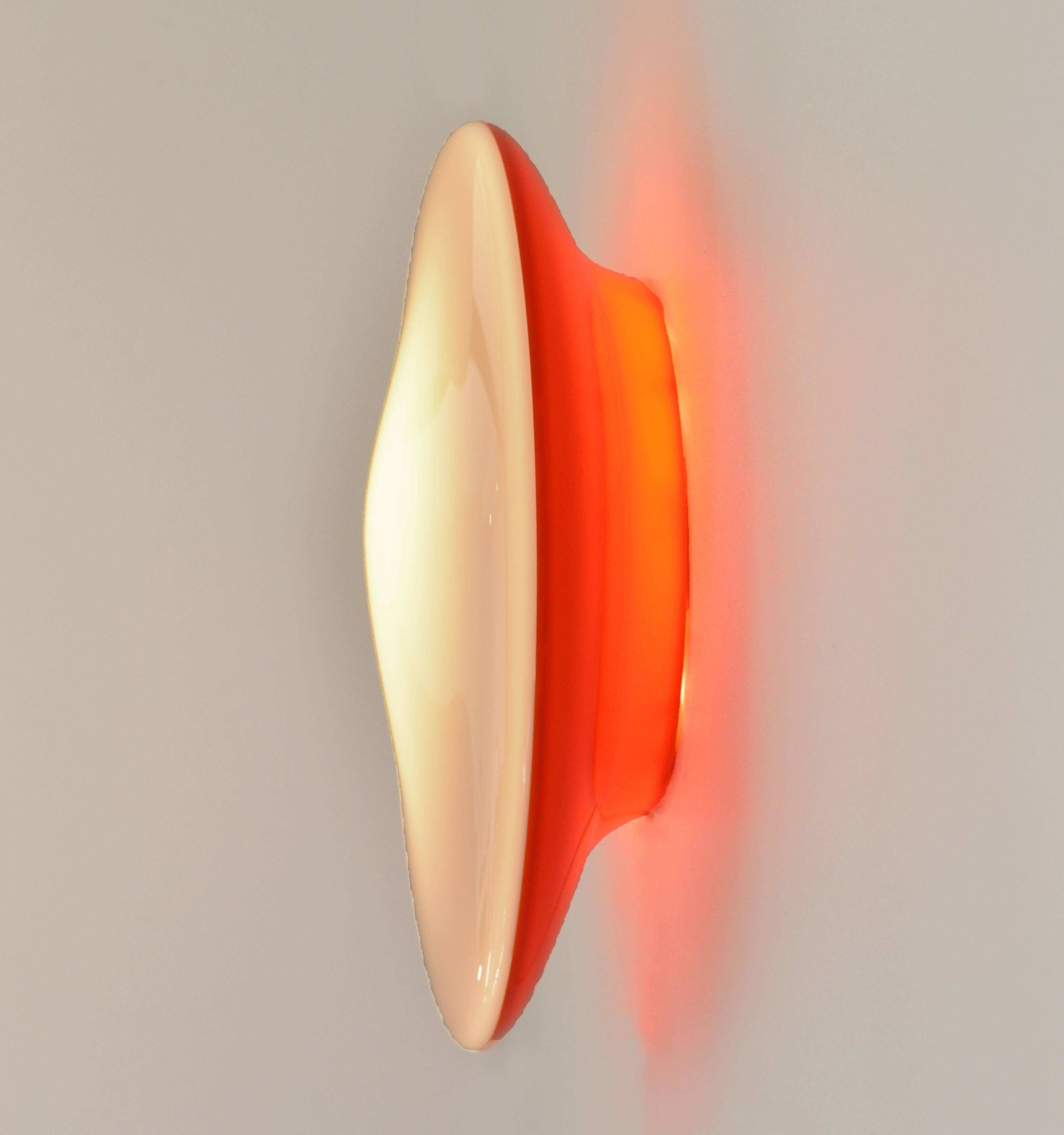 Oval wall lamp Artemide Italy design Patrick Jouin orange and white.