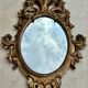 Miroir en bois doré sculpté .