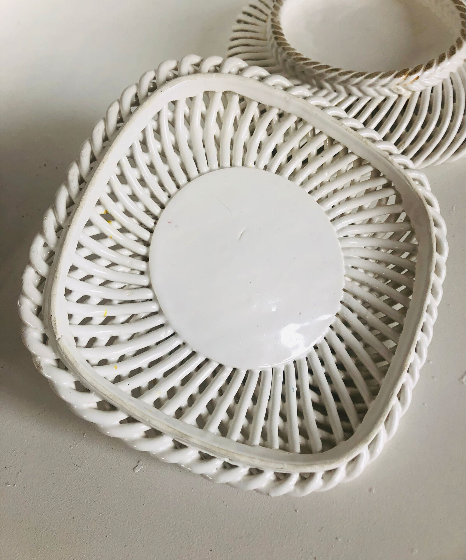 Covered basket in white woven ceramic and fruit slip.