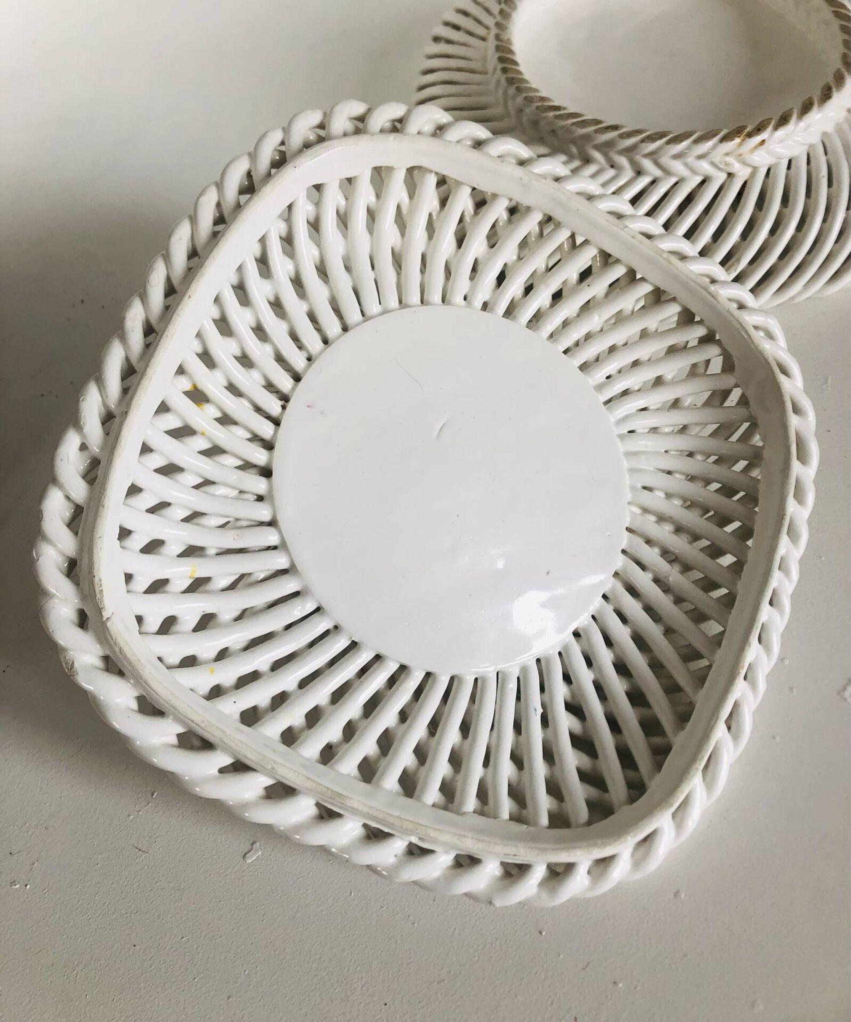 Covered basket in white woven ceramic and fruit slip.