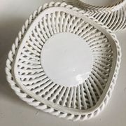 Covered basket in white woven ceramic and fruit slip.
