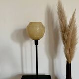 Table lamp with an old vintage glass lampshade, between gold and camel