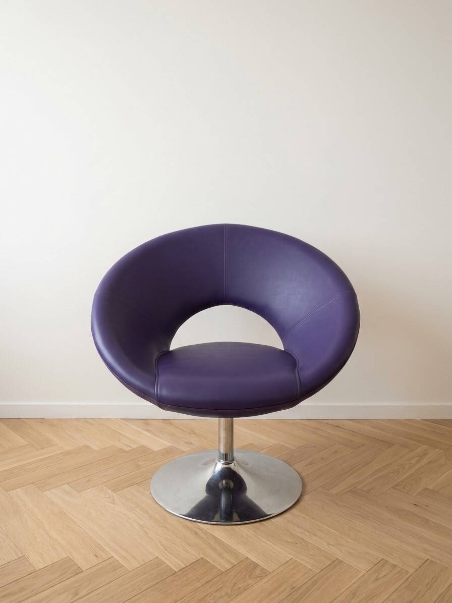 Vintage 70s armchair in purple faux leather with steel legs.