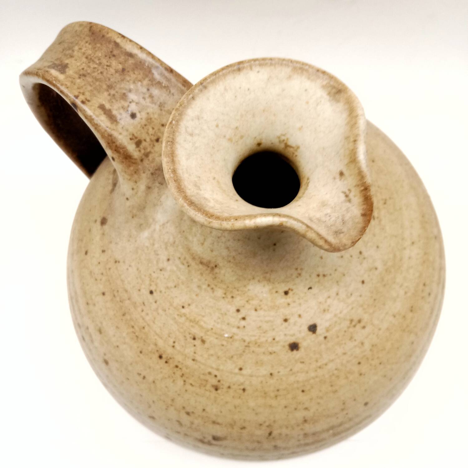 Vintage speckled brown stoneware jug in a round shape.