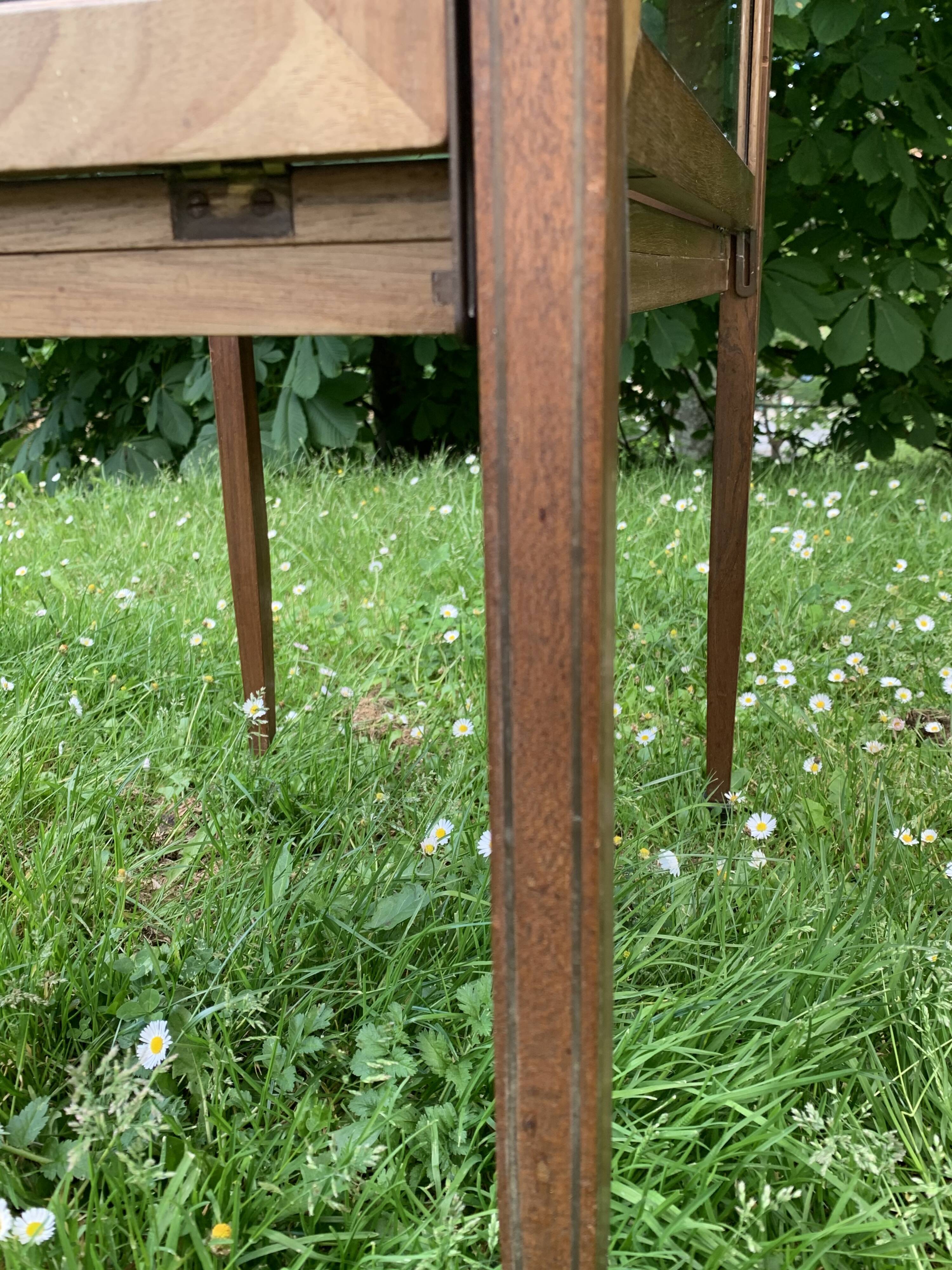 Glass-enclosed old tea table with wooden tray, bronze and brass