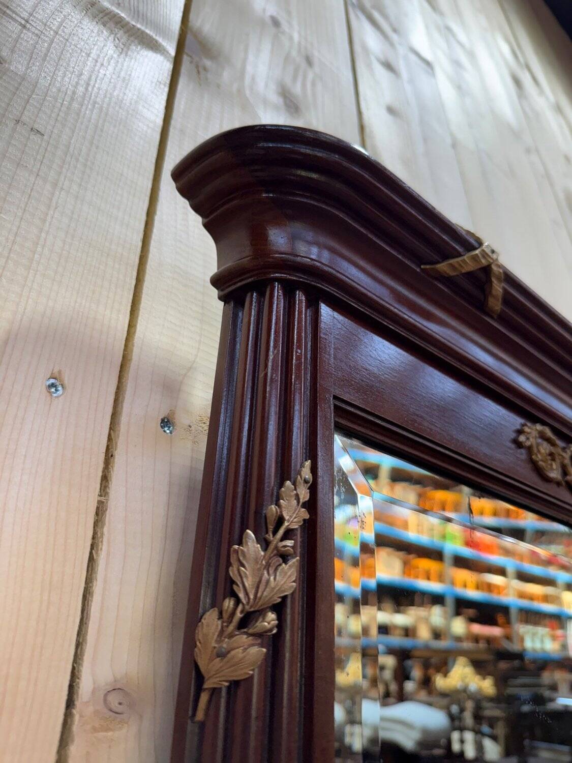 Louis XVI style mirror in mahogany and gold.