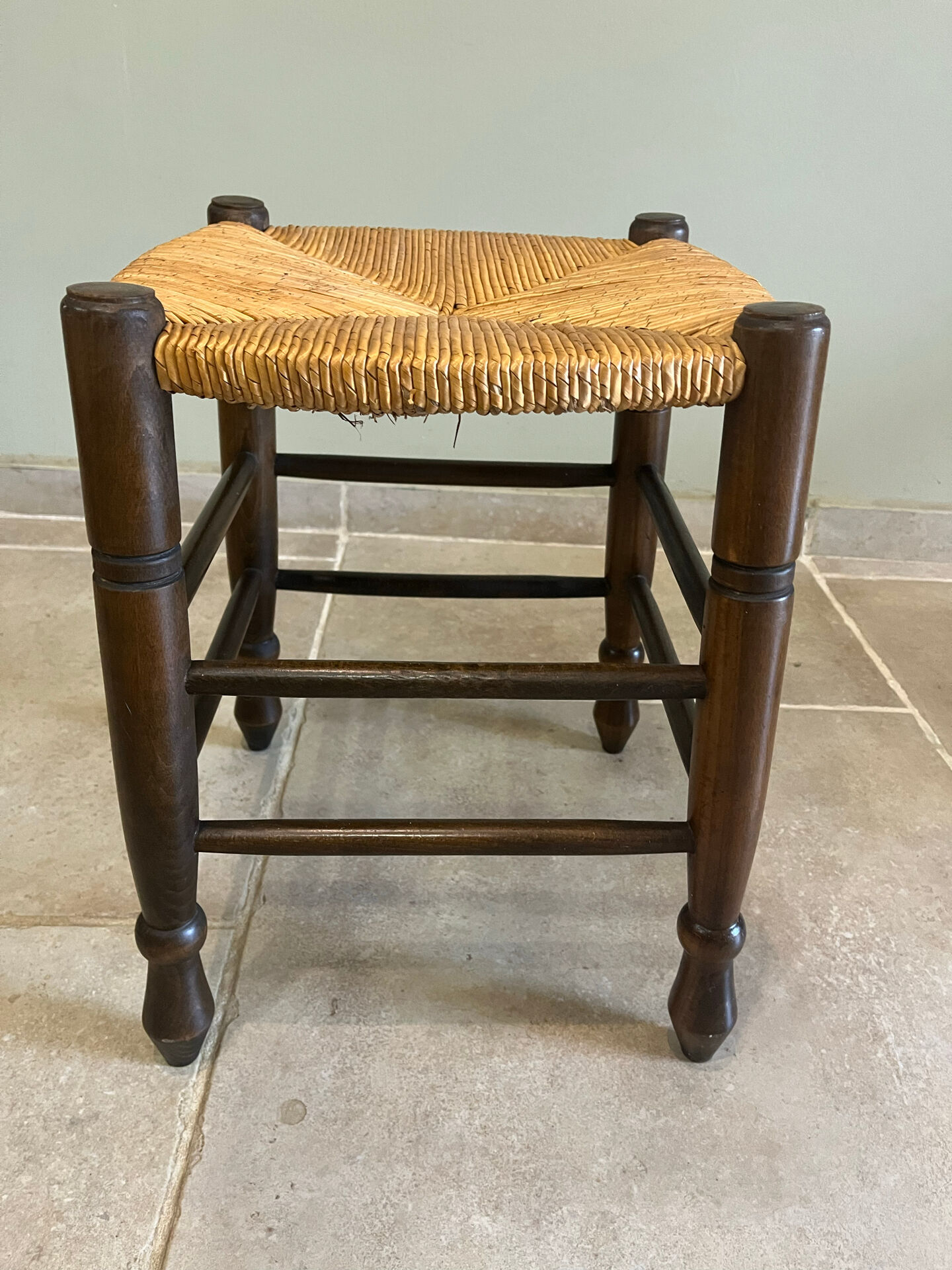 Wooden stool with a straw seat