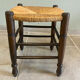 Wooden stool with a straw seat