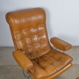 Fauteuil pivotant et son ottoman en cuir