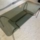 Double top coffee table in smoked glass and tubular structure in chromed steel