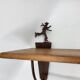 Wall shelf in wood and metal with a decoration of ice skaters.