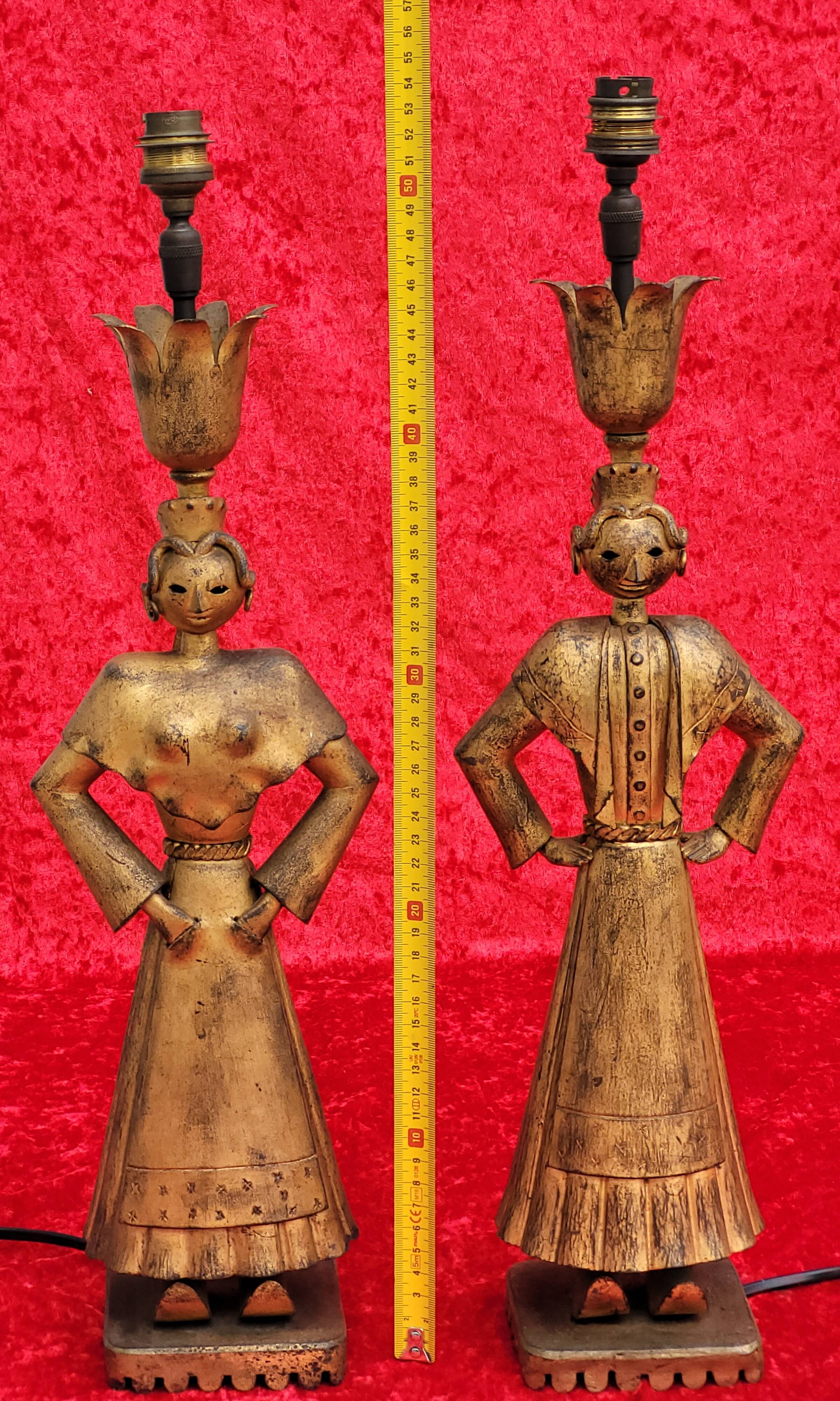 Pair of gilded beaten iron sculpture lamps attributed to Gilbert Poillerat