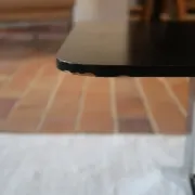 70s design coffee table with a black top and steel legs.